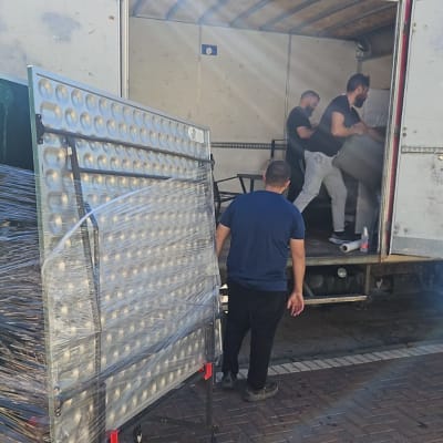 אנשים מעמיסים ציוד למשאית הובלה