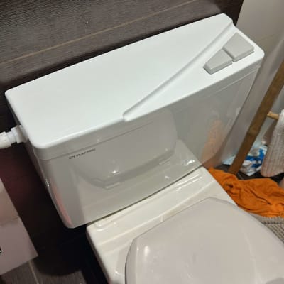 אסלה עם מיכל הדחה לבן בחדר אמבטיה