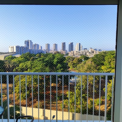 רשת על מרפסת עם נוף לעיר ועצים