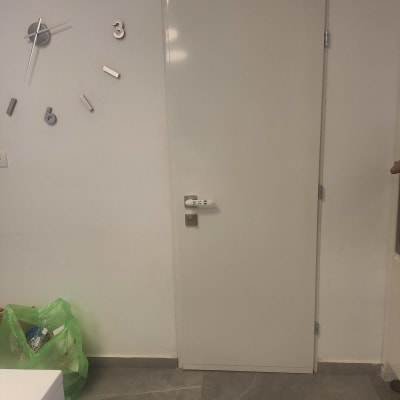 דלת לבנה עם ידית כסופה וקודן