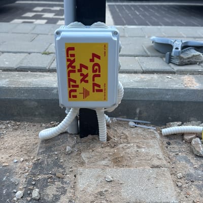 תיבת חשמל עם שלט אזהרה ברחוב