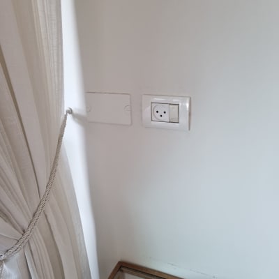 שקע חשמל בקיר ליד וילון