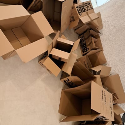 קופסאות קרטון ריקות על הרצפה, מיועדות לאריזה וסידור ביתי