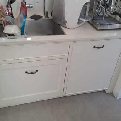 כיור מטבח עם כלים, מכונת קפה וכלי ניקוי