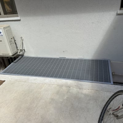 רשת מתכת מותקנת ליד קיר עם מזגן