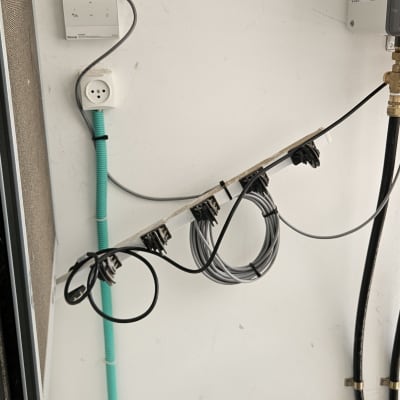 מערכת חיווט וצנרת על קיר לבן