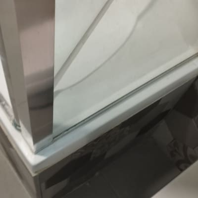 מקלחון עם דלת זכוכית ורצפת אריחים