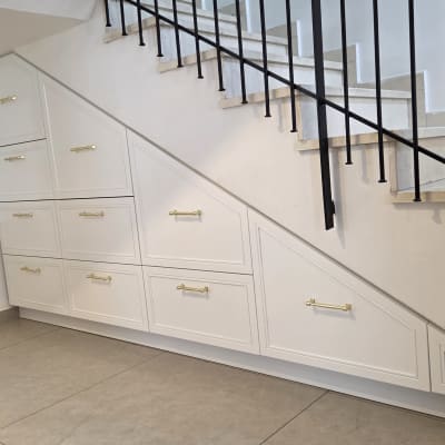 ארונות מובנים מתחת למדרגות עם ידיות זהב