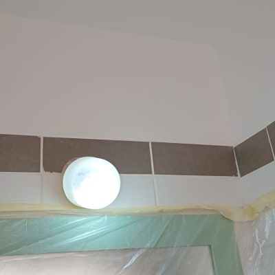 מנורה עגולה על קיר עם אריחים, ניילון מגן