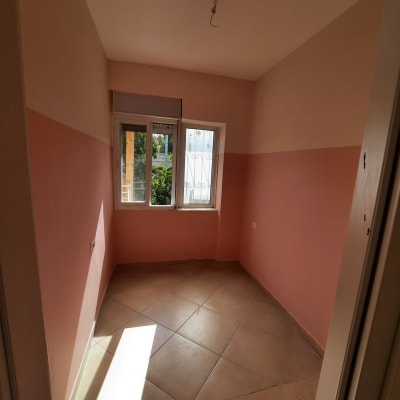 חדר צבוע בגוון ורוד עם חלון פתוח