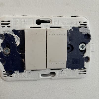 מתג חשמלי על קיר עם סימני תיקון