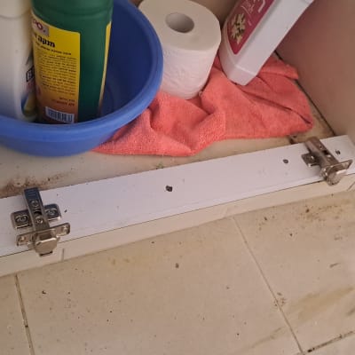 ארון פתוח עם חומרי ניקוי ומגבת
