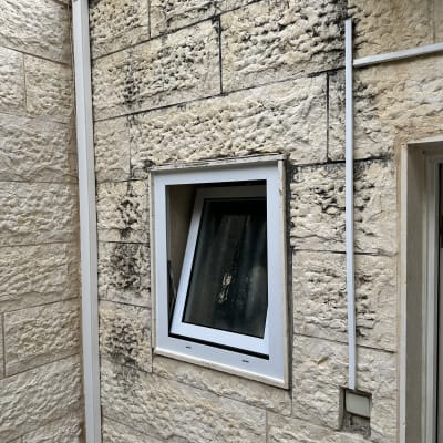 חלון אלומיניום בקיר אבן חיצוני