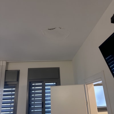 כתם רטיבות בתקרה בחדר עם חלון