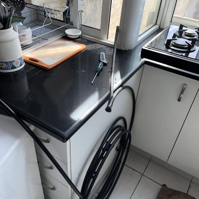 ציוד אינסטלטור וצינור לחץ לפתיחת סתימה במטבח ביתי