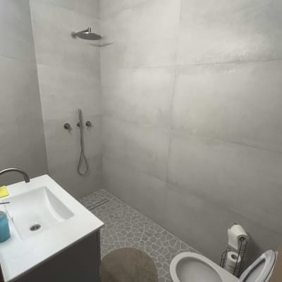 חדר אמבטיה משופץ עם מקלחת וכיור מודרניים