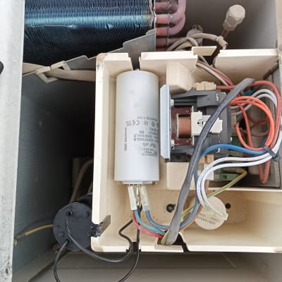 חלקים פנימיים של מזגן עם חוטים וקבלים