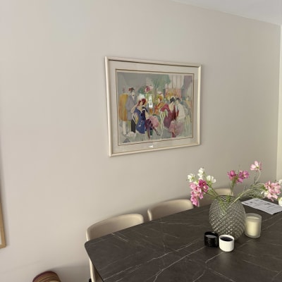 A dining table with a vase of flowers and candles, no handyman elements visible.