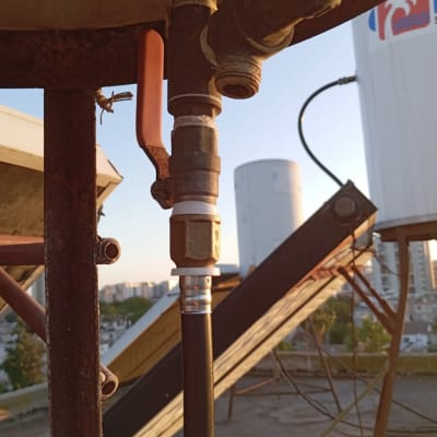 צנרת ומחברים על גג בניין בשקיעה