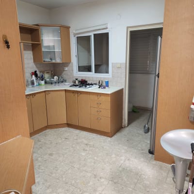 מטבח עם ארונות עץ, כיור וכיריים