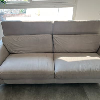 ספה אפורה נקייה עם אור שמש על המושב