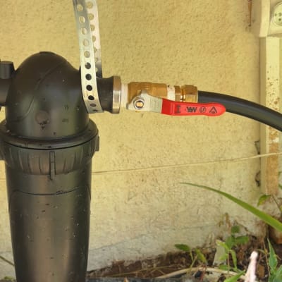 מסנן מים וצינורות מחוברים לקיר