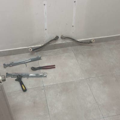 צינורות חימום על הקיר וכלי עבודה על הרצפה