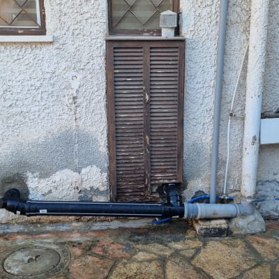 צינורות ביוב חיצוניים מחוברים לקיר בניין