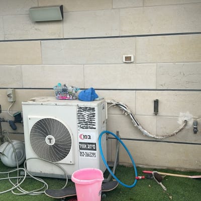 יחידת מיזוג אוויר חיצונית עם צינורות וכלים מסביב