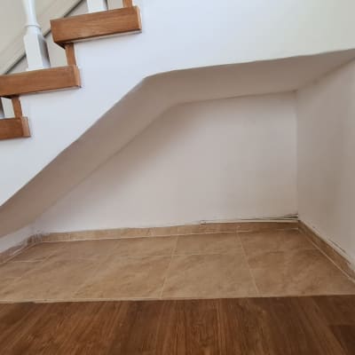 רצפה אטומה מתחת למדרגות עם אריחים חומים