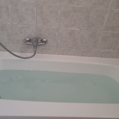 אמבטיה עם מים וקיר אריחים