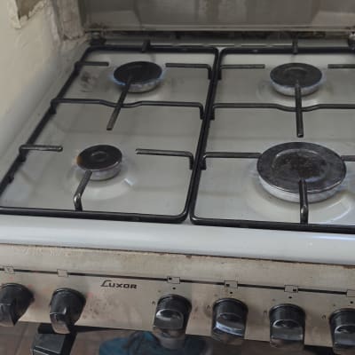 כיריים גז פועלות עם להבות כחולות דולקות בארבעת המבערים