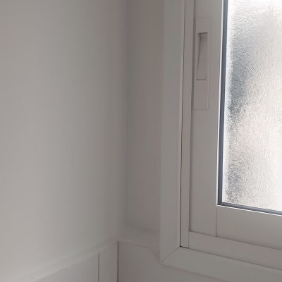 corner of a tiled wall with a window