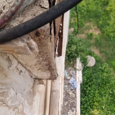 חוטים חשמליים וקיר מתקלף עם סדקים