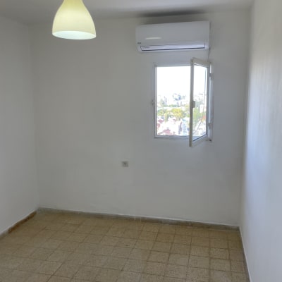 חדר עם קירות צבועים בלבן ותקרה לבנה