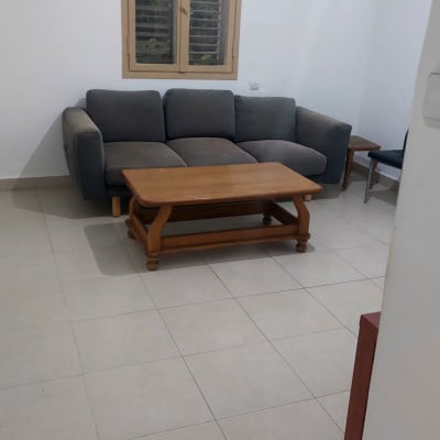 ספה ושולחן עץ בחדר נקי ומסודר