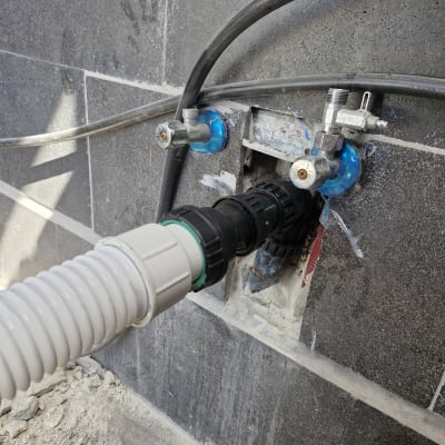 צינור מחובר לשסתומים בקיר אפור