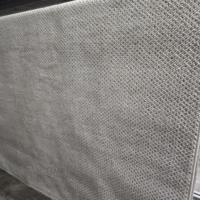 שטיח אפור תלוי לייבוש על מתקן מתכת