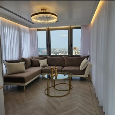 סלון עם ספה חומה ושולחן זכוכית עגול