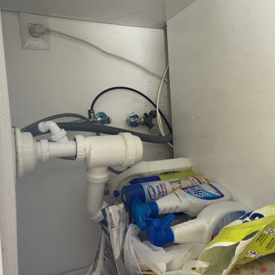 צנרת מתחת לכיור עם חיבורי מים