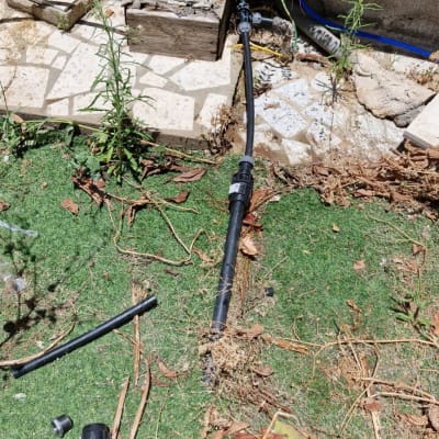 צינור שחור עם מחבר על דשא