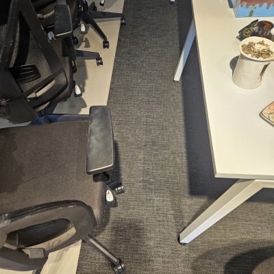 צינור כחול על רצפה ליד כיסאות משרדיים