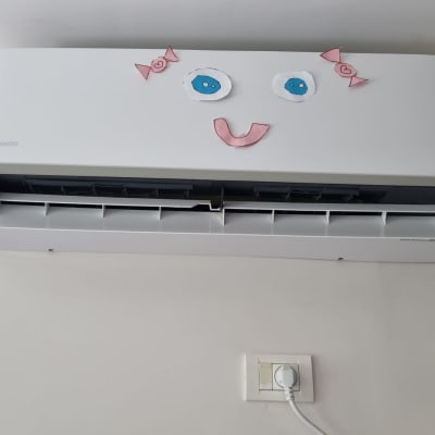 מזגן עם קישוטי נייר בצורת פנים מחייכות