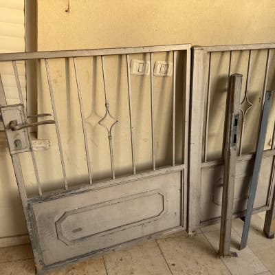 שני שערים מתכת ישנים מונחים על הרצפה