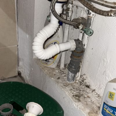 צנרת מתחת לכיור עם חלקי אינסטלציה