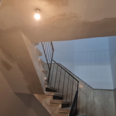 גרם מדרגות עם קירות מטויחים ותאורה