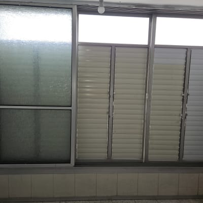 תריסים לבנים על חלון זכוכית גדול