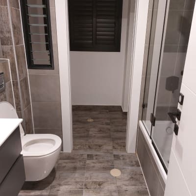 חדר אמבטיה נקי עם שירותים ומקלחת