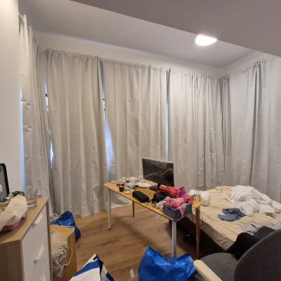 חדר עם וילונות, שולחן, מיטה וכיסא