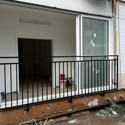 מעקה מתכת שחור מותקן על מרפסת